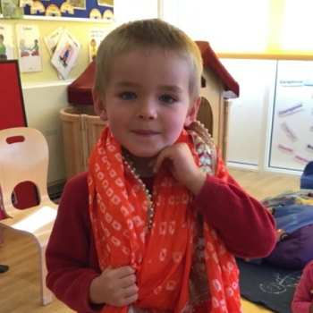 A boy looking at traditional Indian clothes