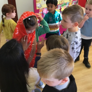 Children looking at traditional Indian clothes
