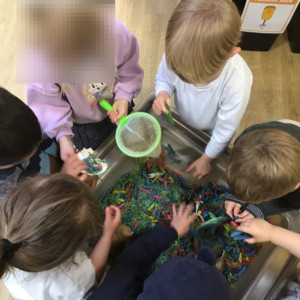 Children playing with dry pasta. 