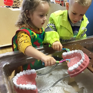 children practising teeth brushing 