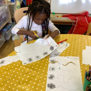 A child cutting something out. 
