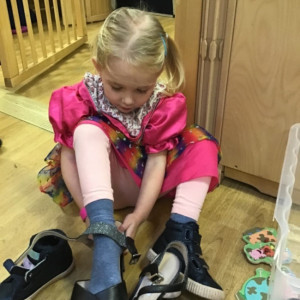 Child putting on shoes