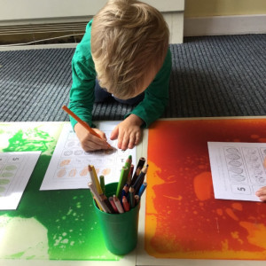 A child drawing with a pencil. 