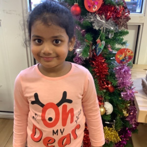 Child by a Christmas Tree