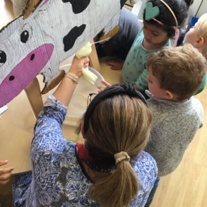 Children with a toy cow