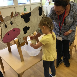 Children with a toy cow