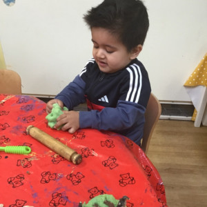 A child playing with Play-Doh. 