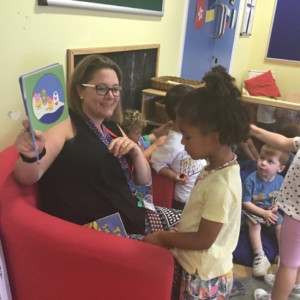 Child with a teacher reaading