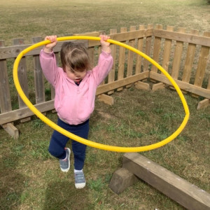 Child playing with a hoop