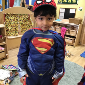Child dressing up as superman