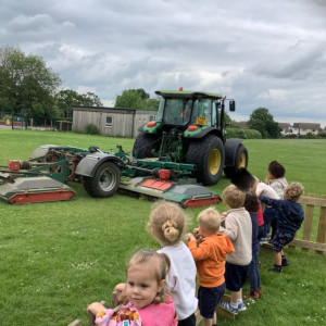 Children watching a tractor