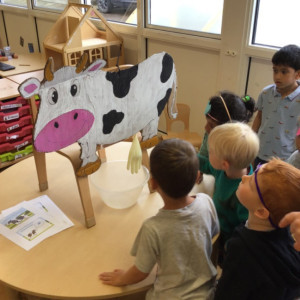 Children with a toy cow
