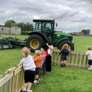 Children watching a tractor 