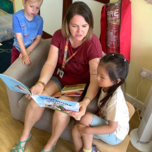 Children and a teacher reading