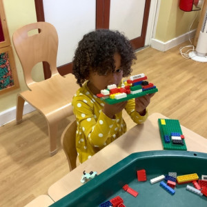 Child paying with Lego