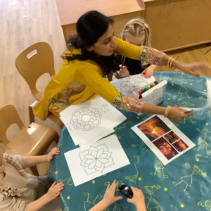 Children round a table colouring