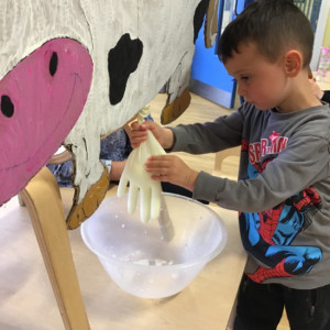 Children with a toy cow