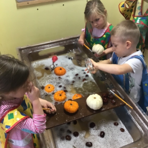 Children carving Pumpkins