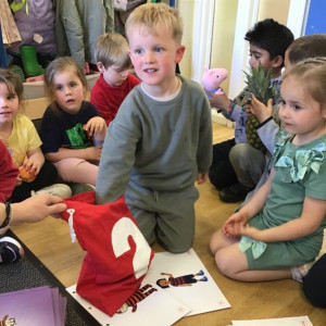 Child picking something out of a bag. 