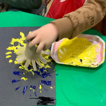 One of the children making a firework painting