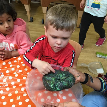 Boy looking at playdough