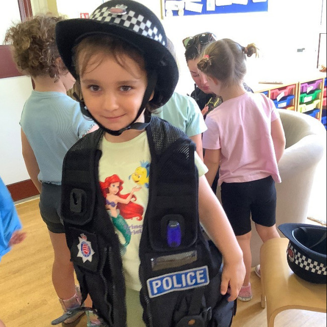 A child in a police coat