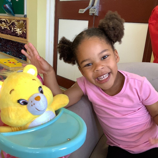 A girl and a teddy bear
