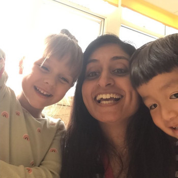 Children and a carer smiling