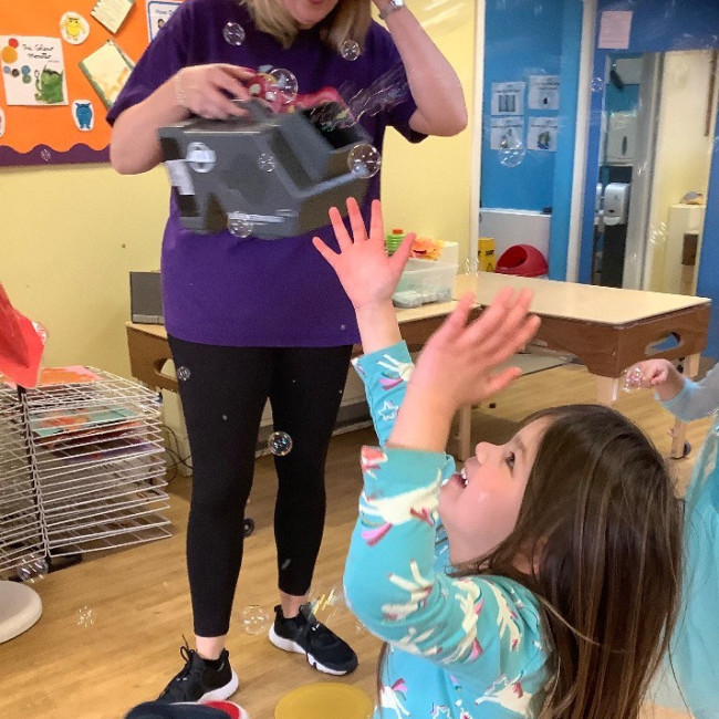 Child playing with bubbles