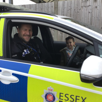 Child looking at a police car