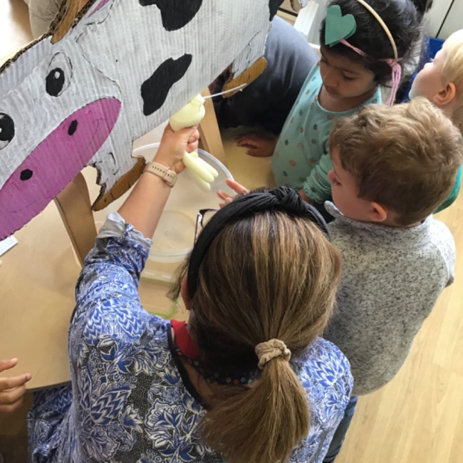 Children with a toy cow