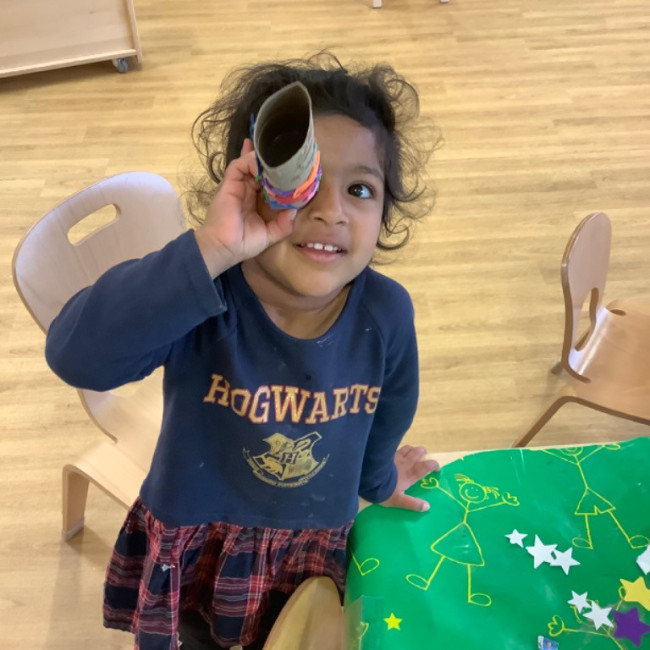 Child looking through a tube