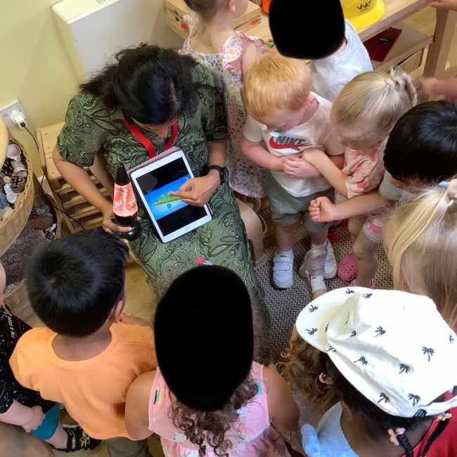 Children in a group listening to a talk