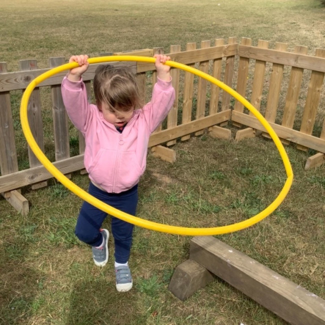 Child playing with a hoop
