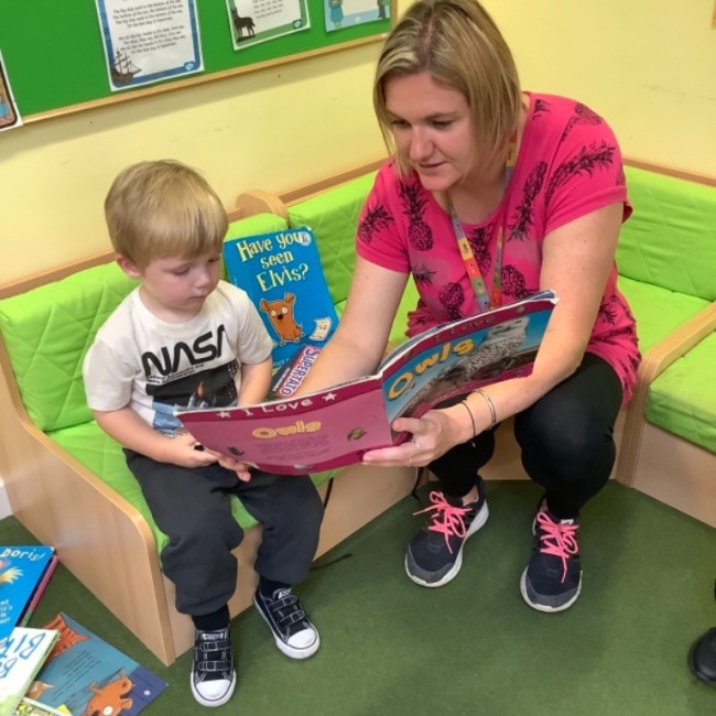 Child reading with a teacher