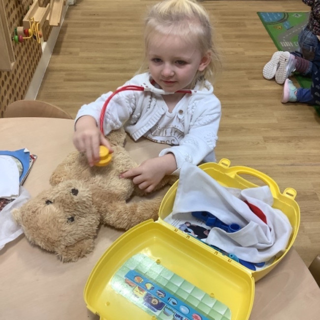 Child playing with a bear