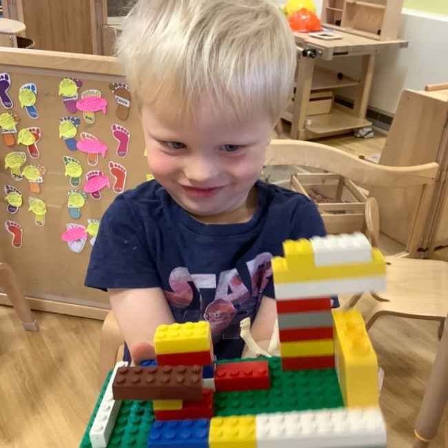 Child paying with Lego