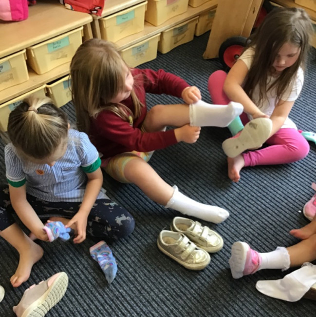 Children putting on shoes