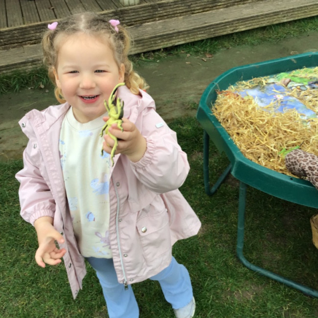 A child with a bug toy. 