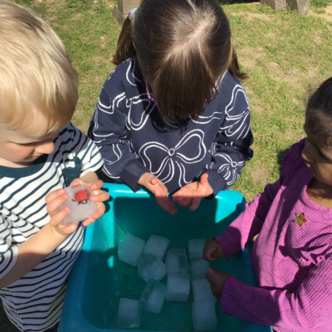 Children playing with ice cubes. 