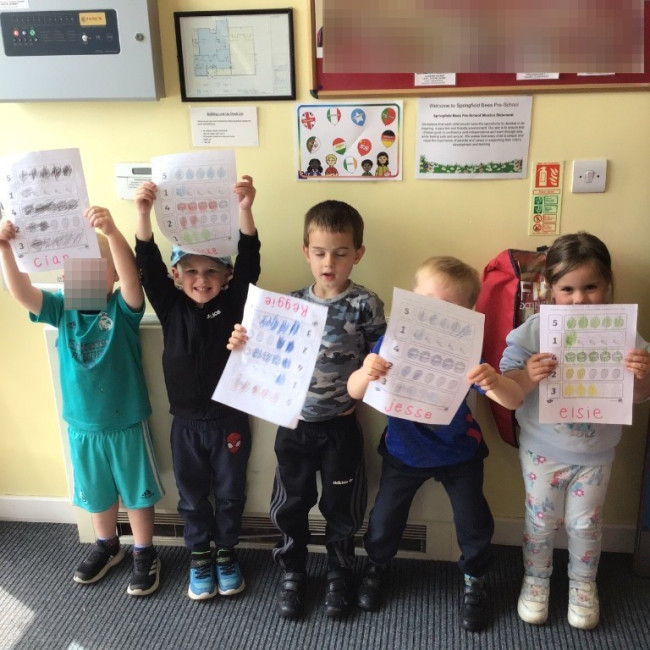 Children showing their artwork. 