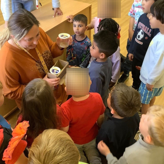 Children listening to a teacher. 