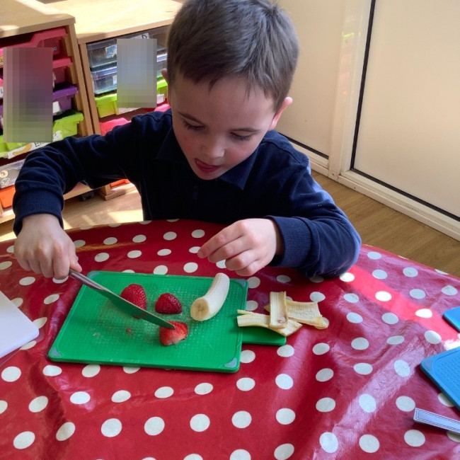 Child cutting our fruit. 