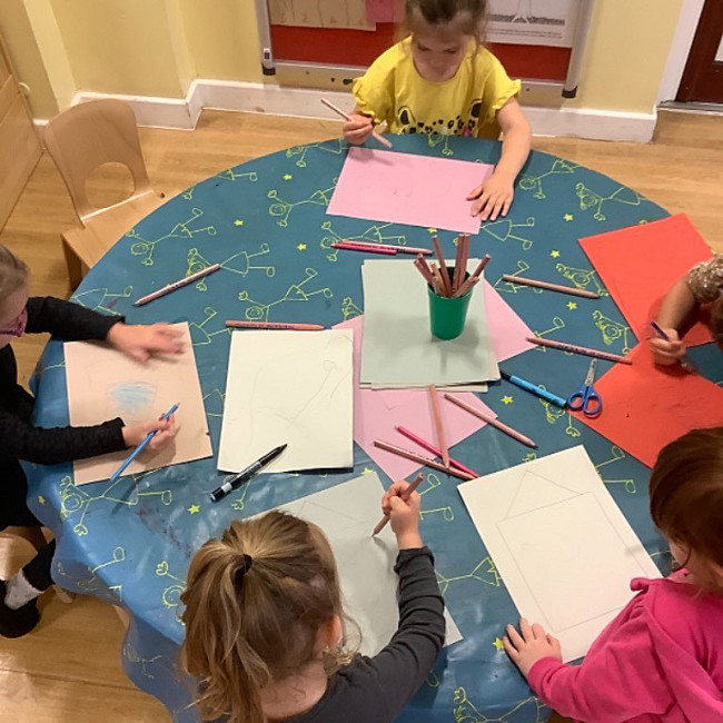 Children drawing pictures of their homes